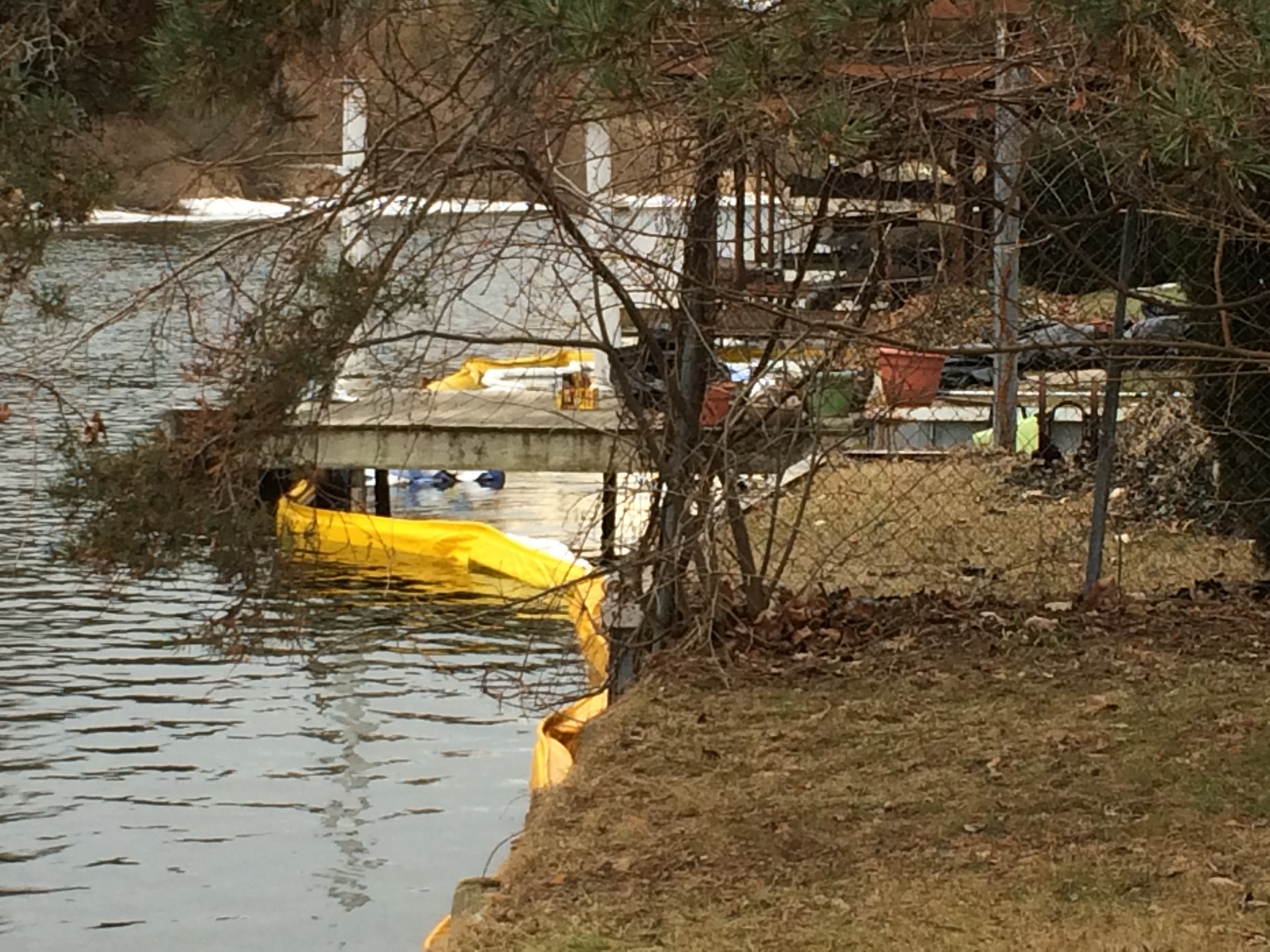 Booms placed in the Huron River to capture oil leaking from an underground storage tank.