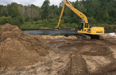 excavator removing sediment