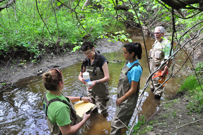 HRWC volunteers collecting stream samples to determine if stormwater management is improving conditions